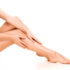 Beautiful smooth and shaved woman's legs on white background. Skincare treatment concept